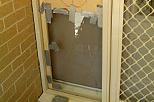 Before image of broken glass panel beside front door