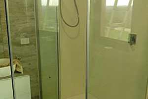 Glass shower install with glass swinging door. Sealed to avoid leaking water.