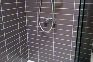 after image of re-grouting and caulking around bath tiles to reseal.
